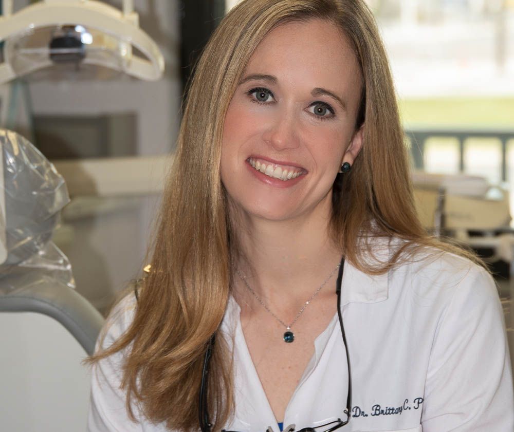 Dr. Brittany Pierpont smiling in a Pier Dental treatment room, emergency dentist in Ybor City, FL