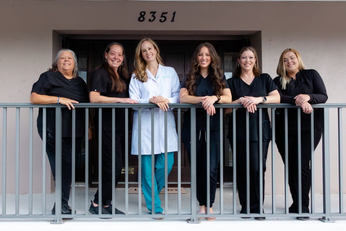 The Pier Dental team on the office balcony, cosmetic dentistry in St. Pete Beach and Pinellas County, FL